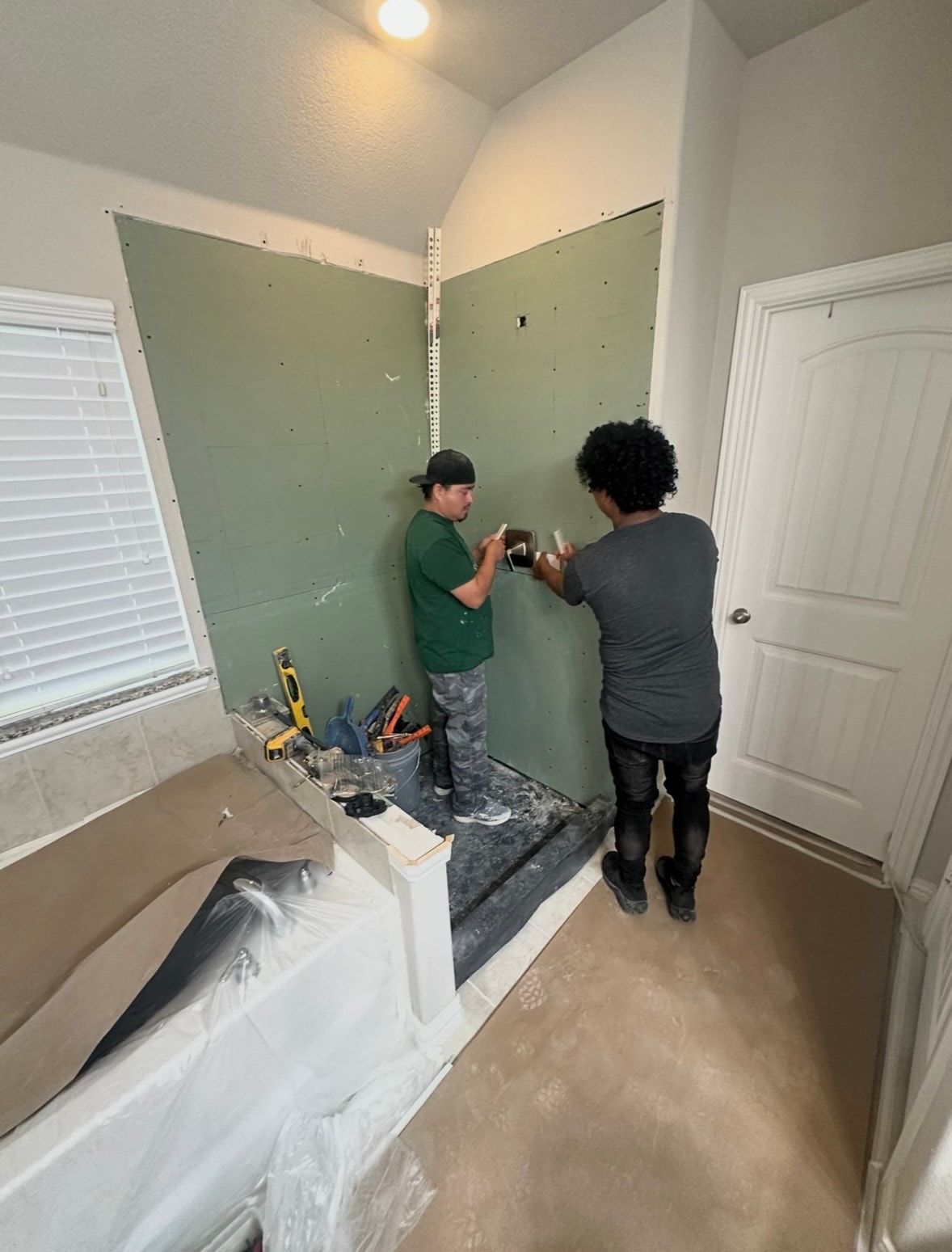 Completed custom tile shower with glass enclosure — North Texas