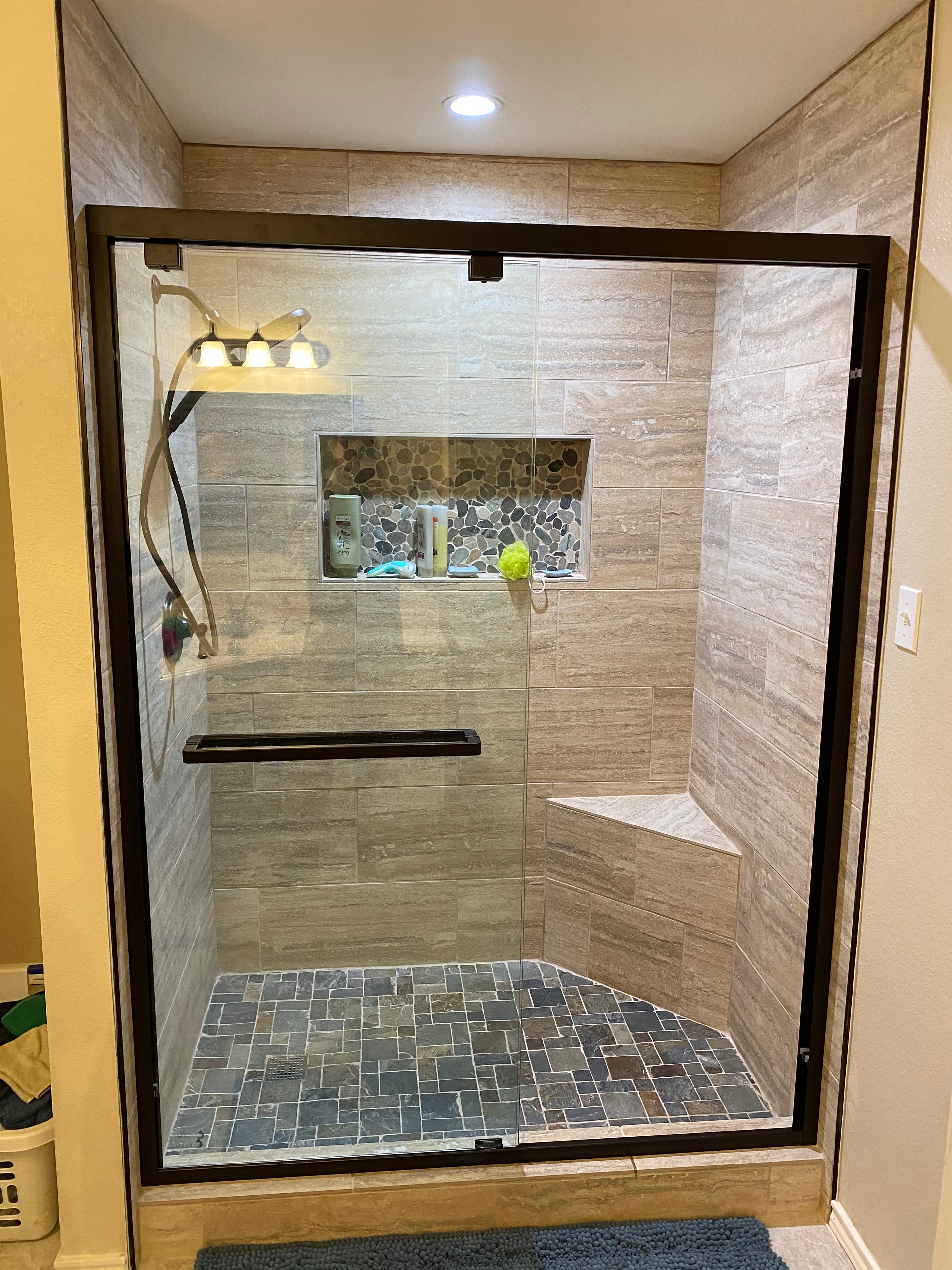 Custom wood-look tile shower with glass enclosure — Frisco TX