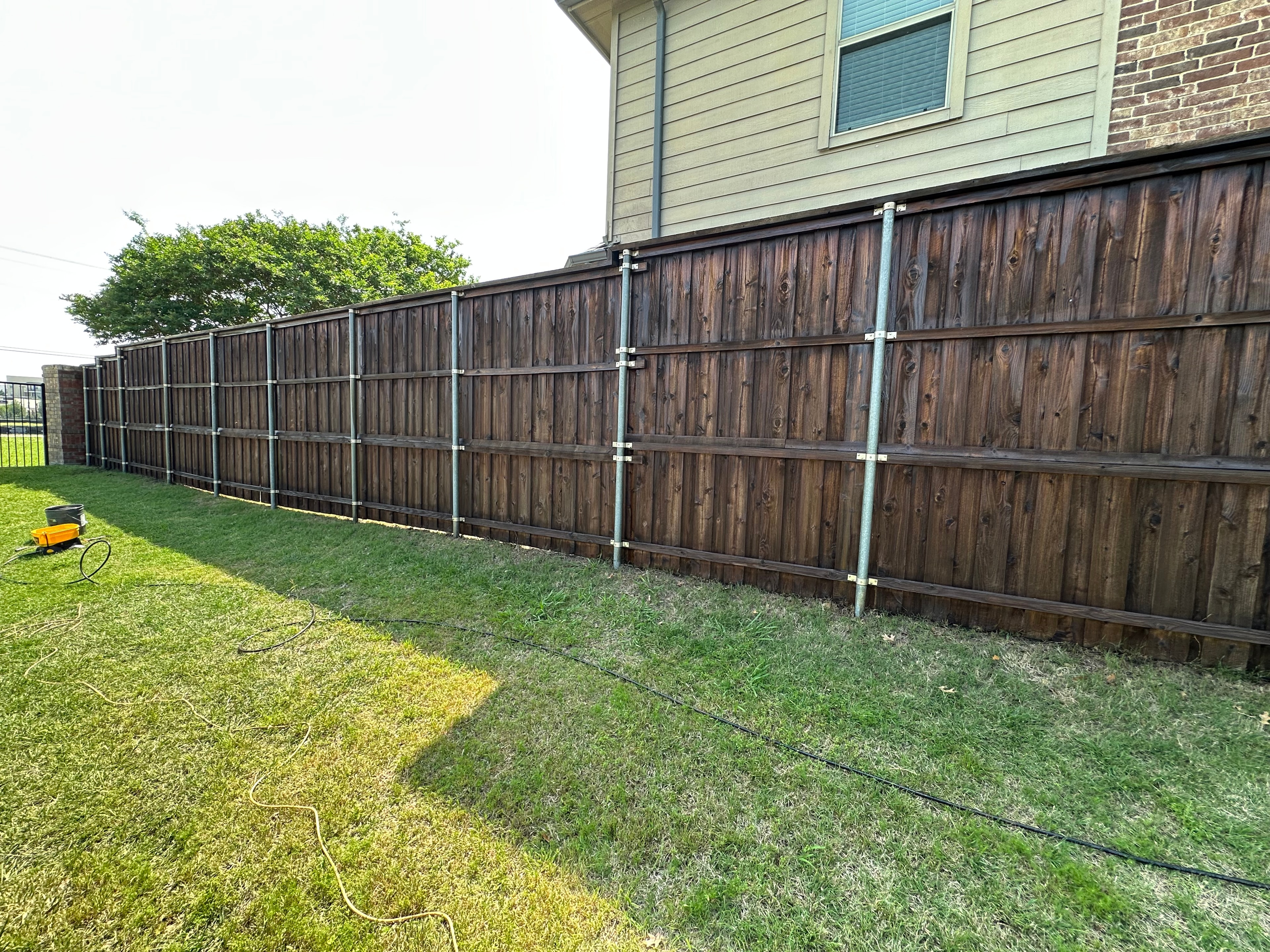 Dark stained fence — front yard completed job