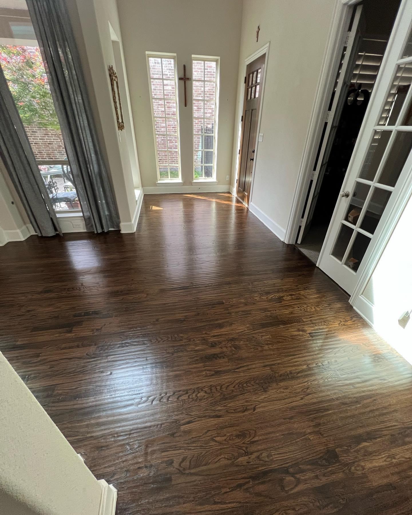 Dark stained hardwood flooring in open entryway — completed job North Texas