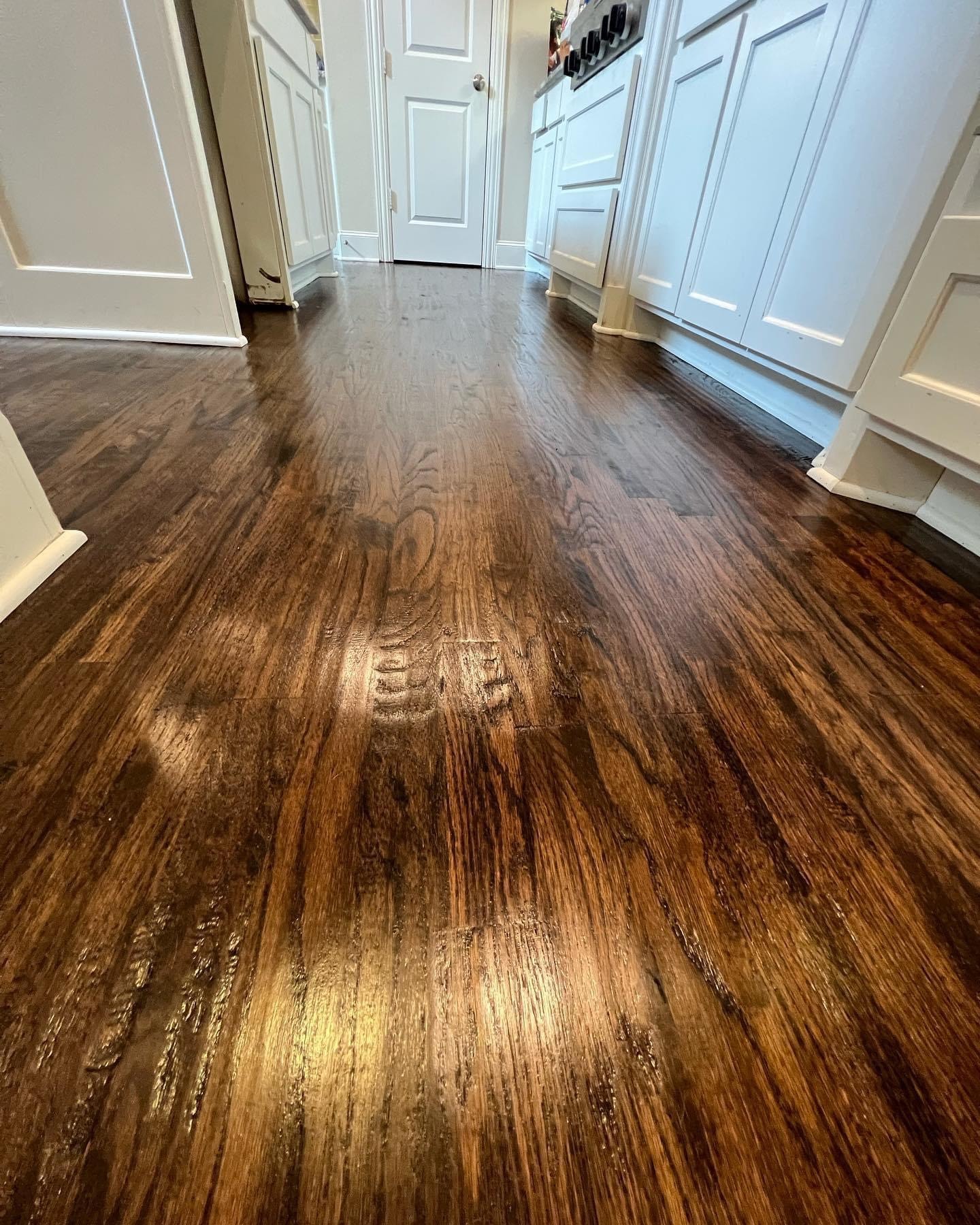 Dark hardwood flooring in kitchen hallway — completed job Frisco TX