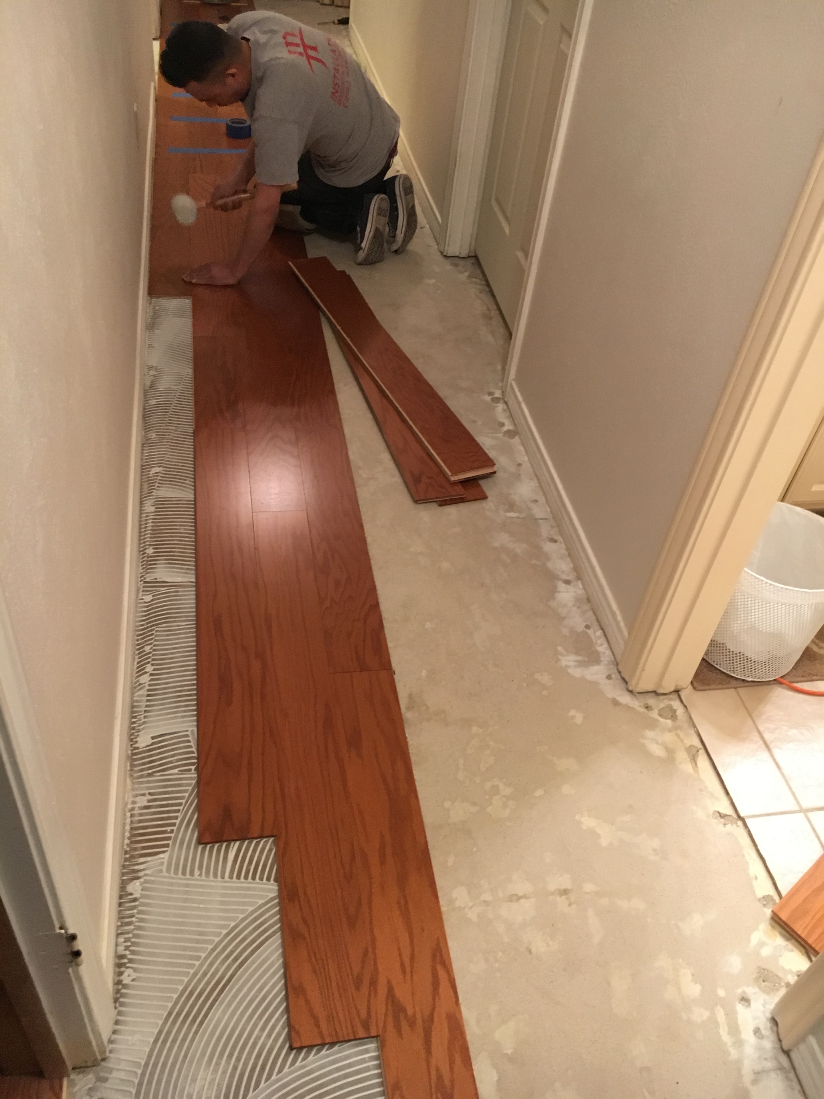Glue-down hardwood flooring installation in progress — North Texas