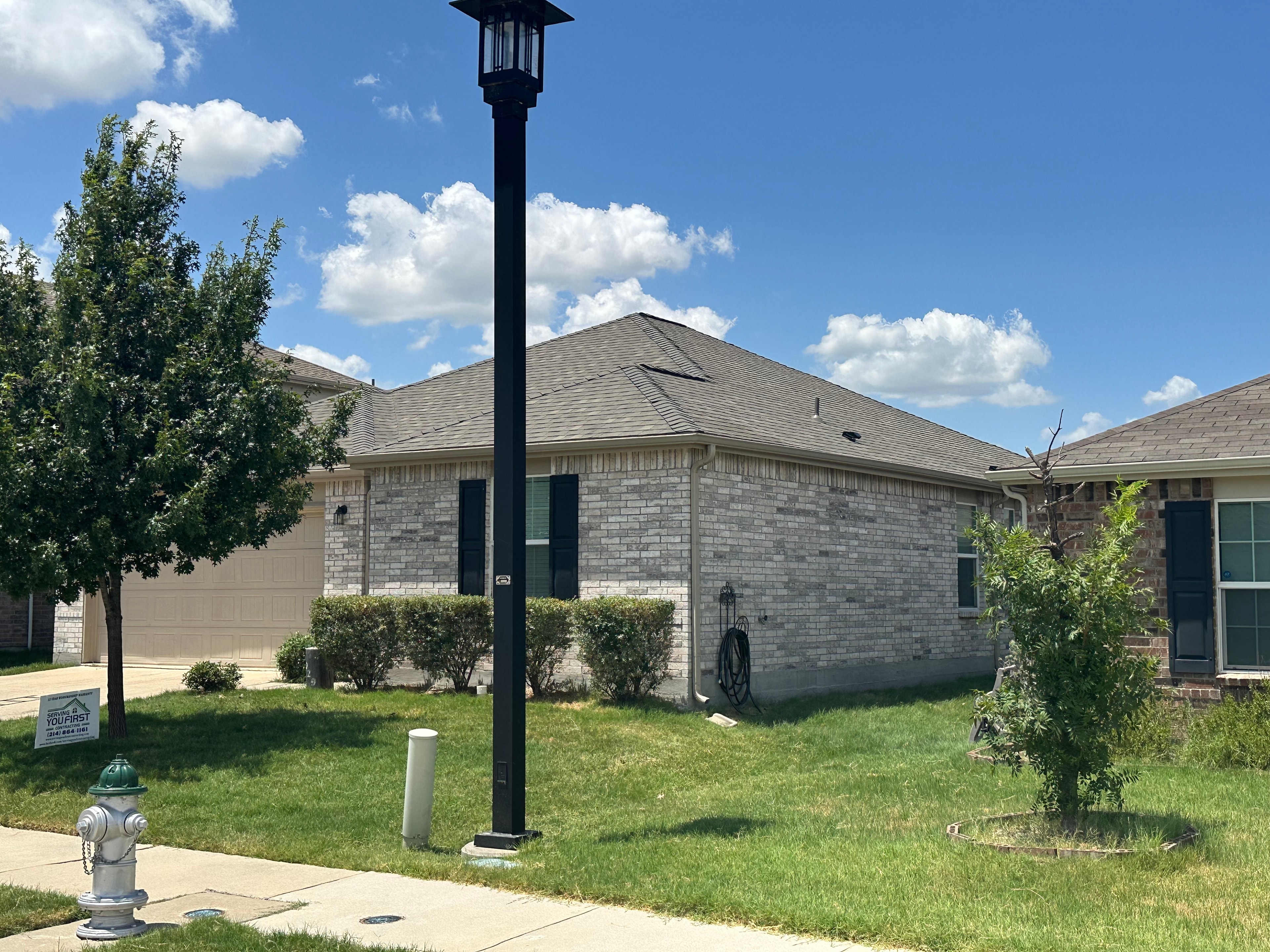 Completed roof on light brick home